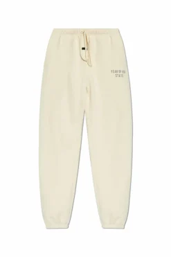Fear Of God Essentials kremowy Spodnie dresowe